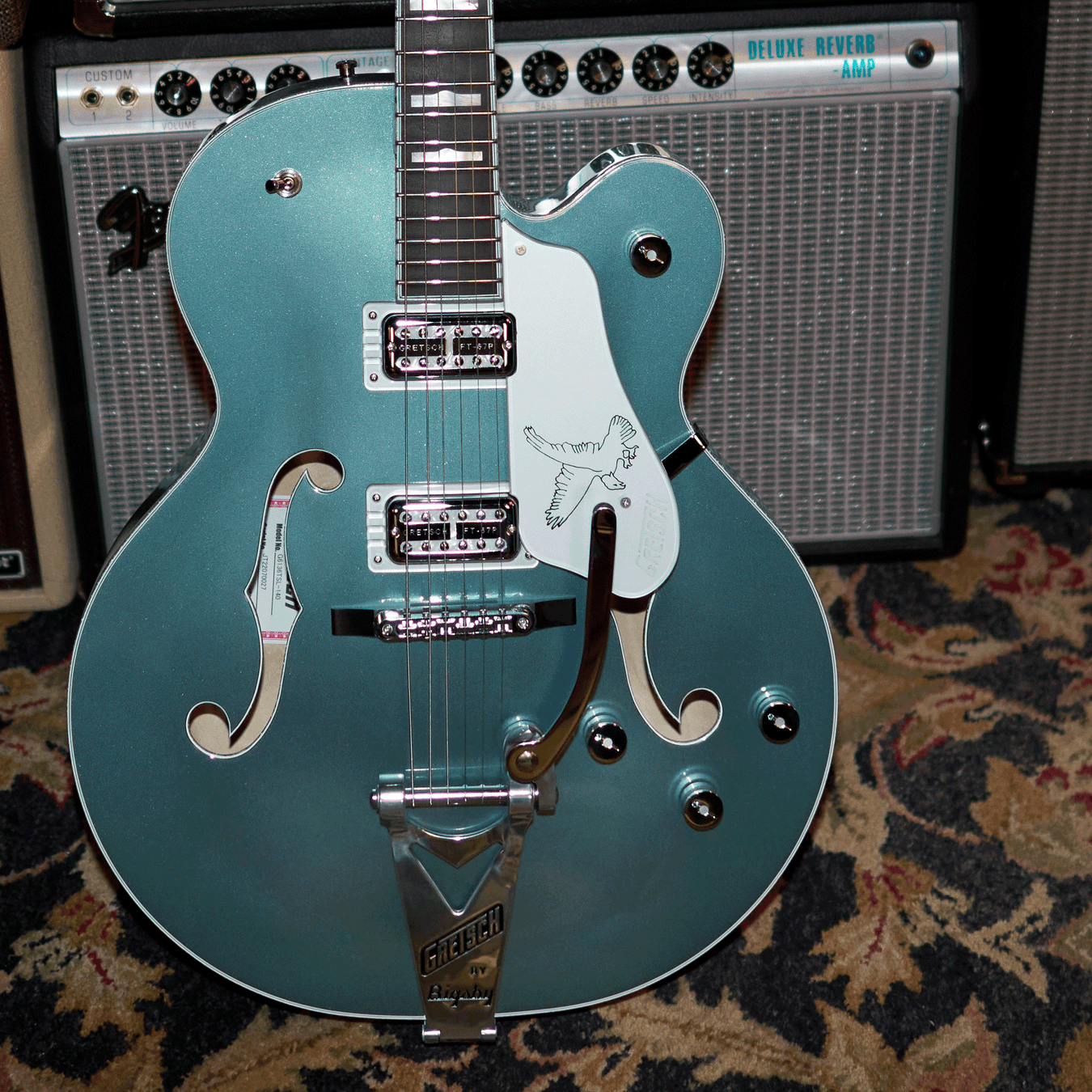 Gretsch Hollowbody leaning against amps