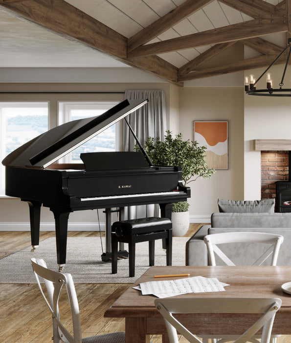 Black Kawai GL-10 grand piano in a modern living room with wooden beams and large windows.